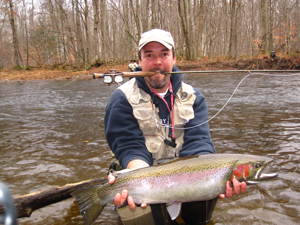 Photo of a person holding a steelhead trout